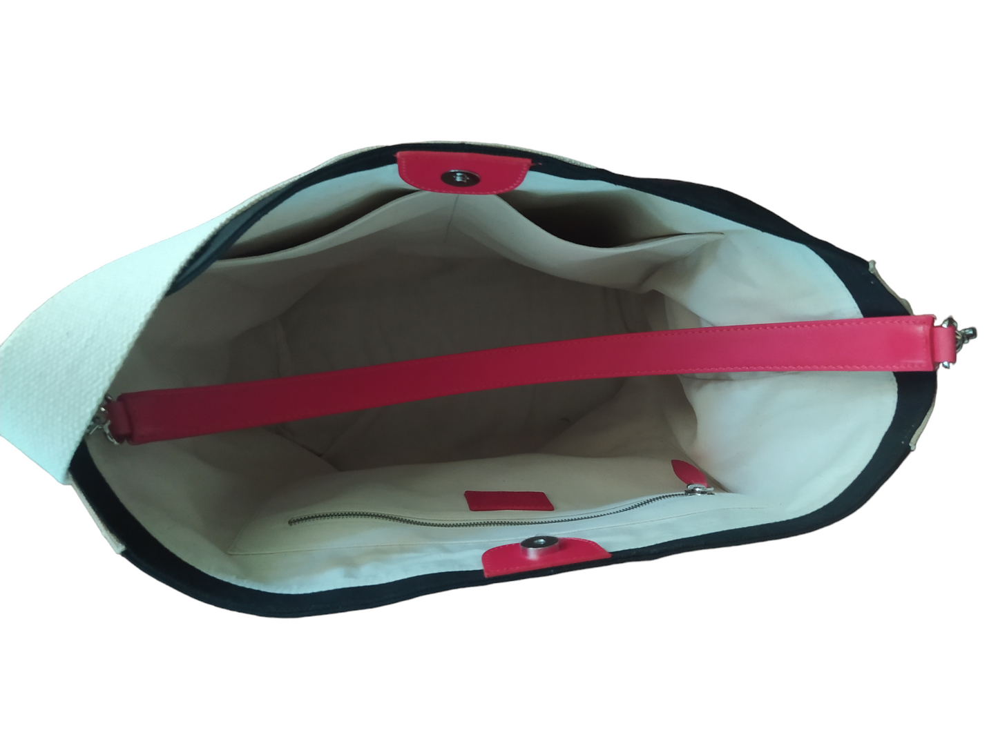 Elegant bucket bag in black and beige canvas. Designed in beautiful cotton canvas, with detachable top leather handle. Lined on the inside with a cotton fabric and has 3 pockets, one of which is large and zipped to lock up your most precious belongings. Spacious enough to fit your 15” laptop, books, water bottle and more, the bag has a magnetic closure to ensure the inside. 100% cotton canvas and Vegan Leather.