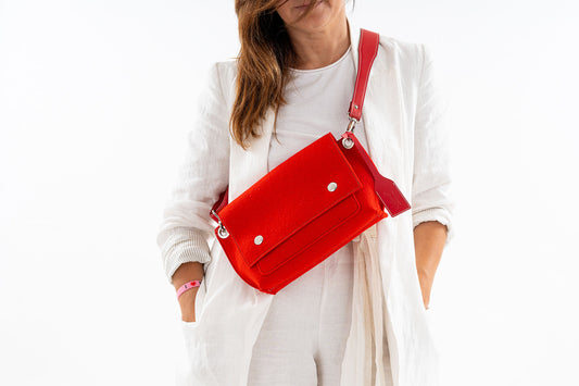 GREGOR Red Beltbag: Compact yet spacious, made from 3mm merino wool felt with vegan leather. Features two external pockets for large phones, a small internal pocket, and a secure flap with magnetic buttons. Adjustable strap for versatile wear. Handmade in Italy. Includes dust bag. - Lefrac