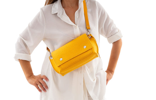 GREGOR Yellow Beltbag: A light, compact, yet spacious belt bag crafted from 3mm Merino wool felt and vegan leather. Features include two external pockets for large phones, a small internal pocket for essentials, a flap with magnetic closure, and an adjustable strap for versatile wear. Handmade in Italy. - Lefrac