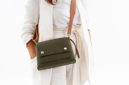 JOY Moss Green Crossbody Bag: Small, ergonomic, and stylish with three pockets (2 external, 1 internal) for essentials. Features an adjustable vegan leather strap, flap closure with magnetic buttons, and a versatile design for comfort and convenience. Ideal for daily errands.