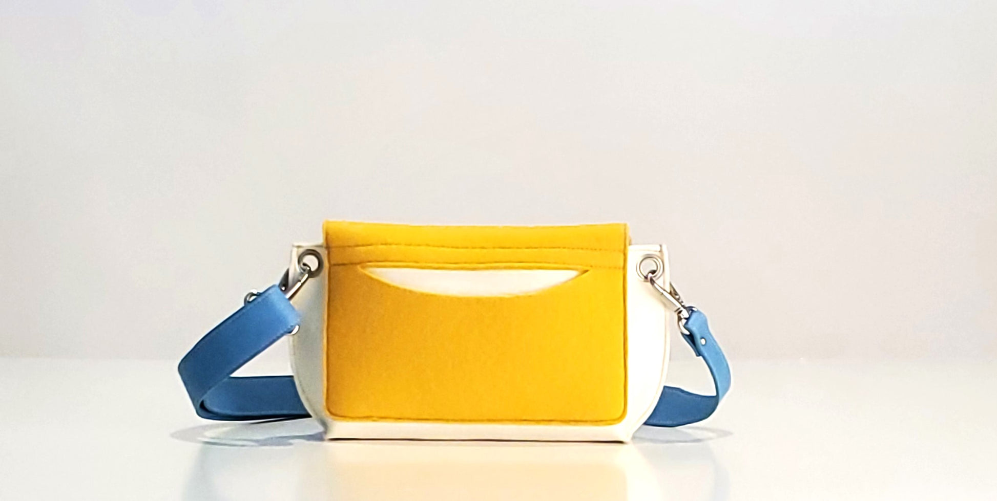 GREGOR Yellow Multi-Color Belt Bag: Light, compact, and surprisingly spacious. Features include two external pockets for large phones, a smaller internal pocket, and a versatile adjustable strap. Made from durable 3mm Merino wool felt and eco-friendly vegan leather. Closure with flap and magnetic buttons. Handmade in Italy. - Lefrac