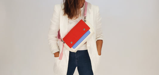 GREGOR Red Beltbag: Compact yet spacious, made from 3mm merino wool felt with vegan leather. Features two external pockets for large phones, a small internal pocket, and a secure flap with magnetic buttons. Adjustable strap for versatile wear. Handmade in Italy. Includes dust bag. - Lefrac