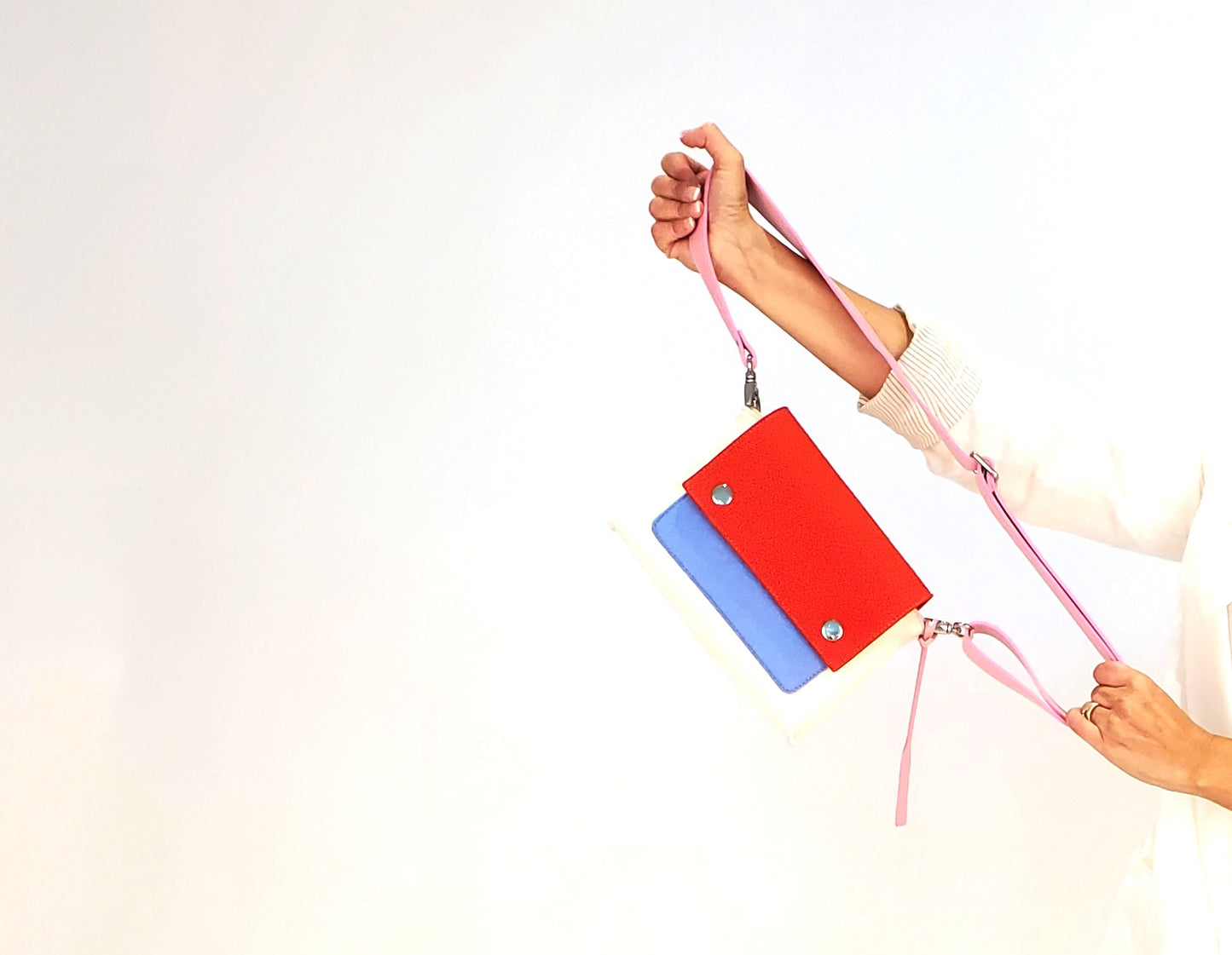 JOY Red Multi-Color Crossbody Bag: Small, ergonomic, and vibrant with adjustable strap. Made from 3mm Merino wool felt and eco-friendly vegan leather. Features three pockets for organization—back pocket for phone, front, and internal pockets for keys and documents. Flap closure with magnetic buttons. Handmade in Italy. - Lefrac