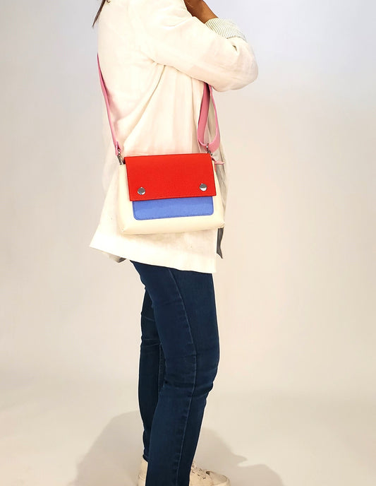 JOY Red Multi-Color Crossbody Bag: Small, ergonomic, and vibrant with adjustable strap. Made from 3mm Merino wool felt and eco-friendly vegan leather. Features three pockets for organization—back pocket for phone, front, and internal pockets for keys and documents. Flap closure with magnetic buttons. Handmade in Italy. - Lefrac