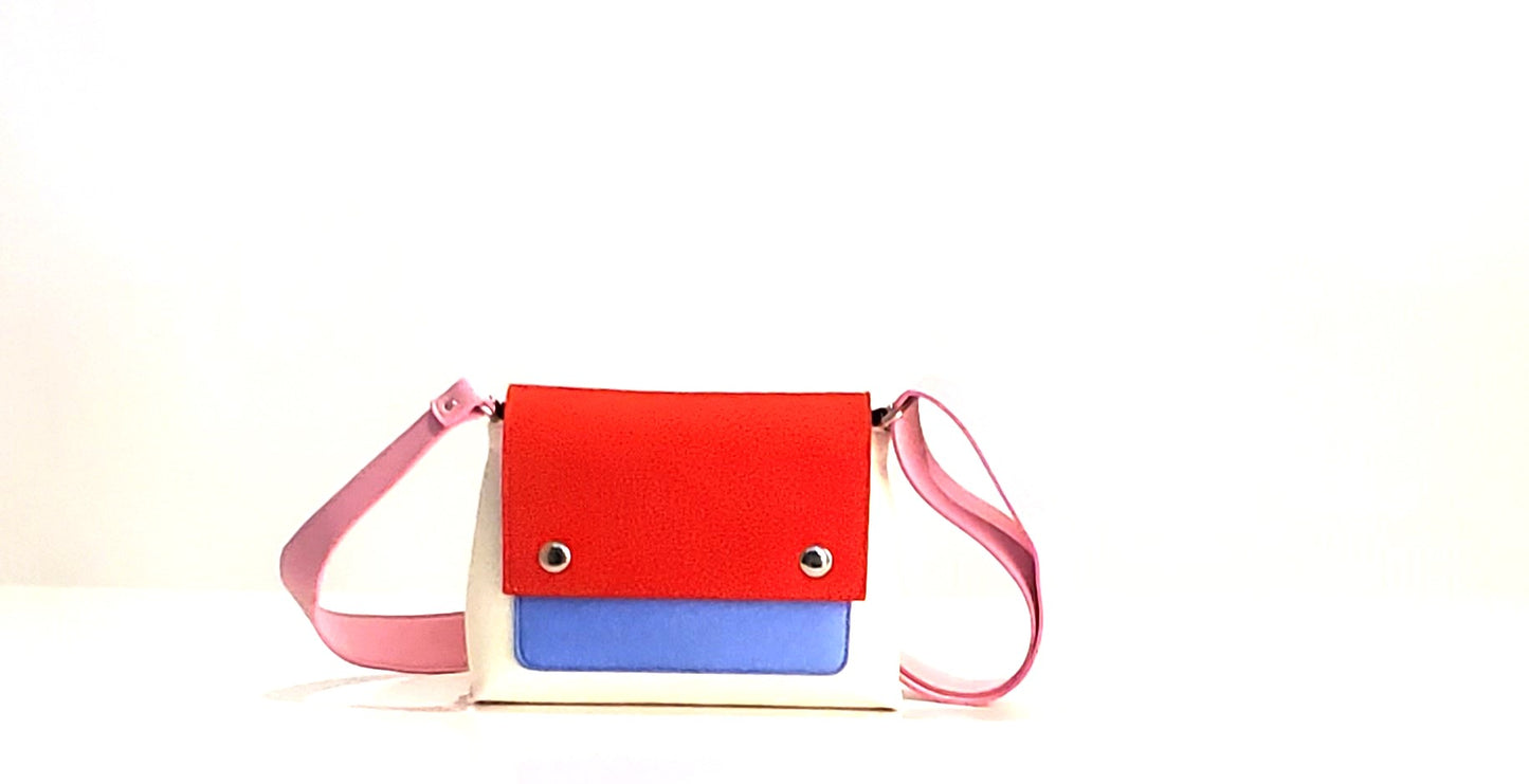 JOY Red Multi-Color Crossbody Bag: Small, ergonomic, and vibrant with adjustable strap. Made from 3mm Merino wool felt and eco-friendly vegan leather. Features three pockets for organization—back pocket for phone, front, and internal pockets for keys and documents. Flap closure with magnetic buttons. Handmade in Italy. - Lefrac